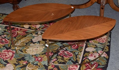 Lot 388 - A pair of walnut oval leaf design side tables, on metal form legs, 90cm by 45cm by 41cm