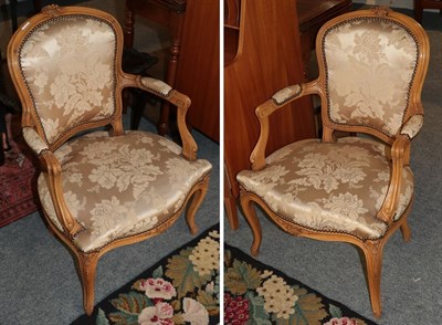 Lot 391 - A pair Louis XV style fauteils with moulded frames, upholstered in silk floral fabric