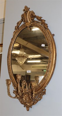 Lot 404 - An oval gilt wood girandole with a leaf carved surmount, 97cm by 56cm