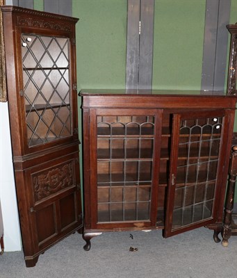 Lot 412 - A 1930's leaded glazed oak bookcase, 120cm by 36cm by 129cm high; together with a reproduction...