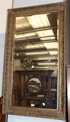 Lot 413 - ^ A large rectangular gilt framed mirror, the bevelled plate within a conforming frame moulded with