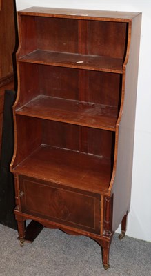 Lot 414 - A reproduction inlaid mahogany three-tier waterfall bookcase, fitted with a base cupboard and...