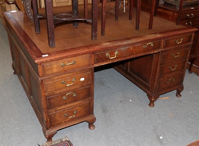 Lot 439 - A leather inset oak partners desk, bearing label for ''A. GARDNER & SON LTD, House Furnishers,...