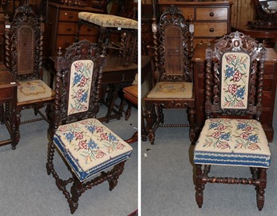 Lot 443 - A pair of 17th century style carved and turned oak hall chairs with wicker backs and needlework...