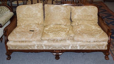 Lot 457 - An early 20th century double caned three seater bergere sofa, 180cm wide