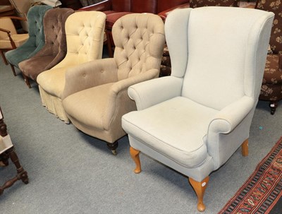 Lot 461 - ^ A group of upholstered chairs comprising a wing back, four button backs, and two open arm tub...