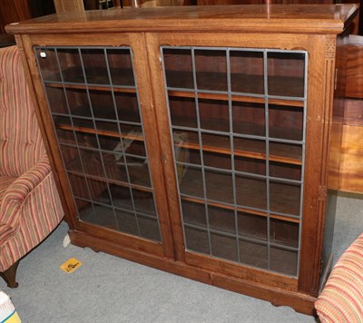 Lot 478 - A mahogany leaded and glazed bookcase with adjustable shelves, 123cm H by 142cm W by 26cm D