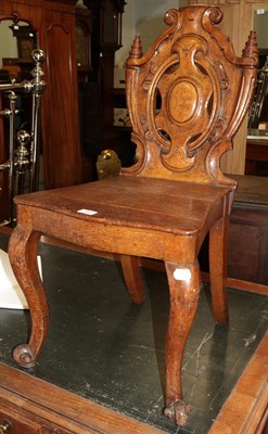 Lot 480 - A 19th century carved oak shield back chair