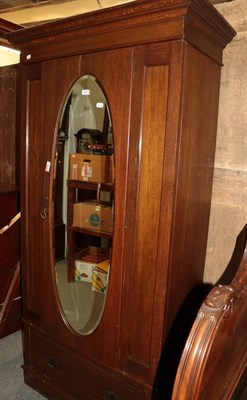 Lot 493 - ^ An early 20th century mirrored oak single wardrobe in the Arts & Crafts taste