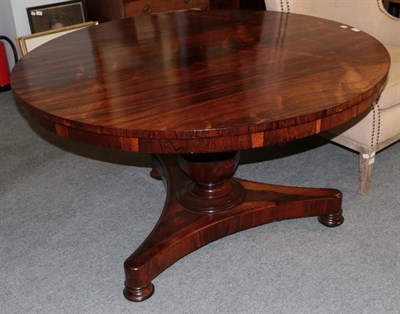 Lot 513 - An early Victorian rosewood circular dining table raised on a faceted baluster support and a...