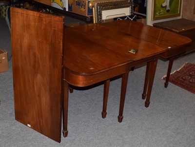 Lot 522 - A George III string inlaid mahogany D-end dining table, raised on tapering square section legs...