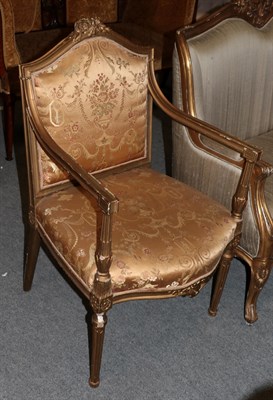 Lot 529 - A French Louis XVI style gilt framed open armchair with floral embroidered gold silk upholstery