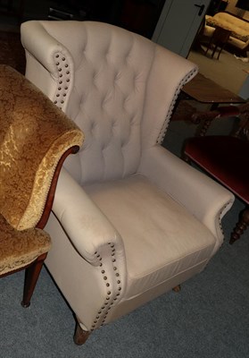 Lot 532 - A George III style button-back wingback armchair with studded decoration (faded)