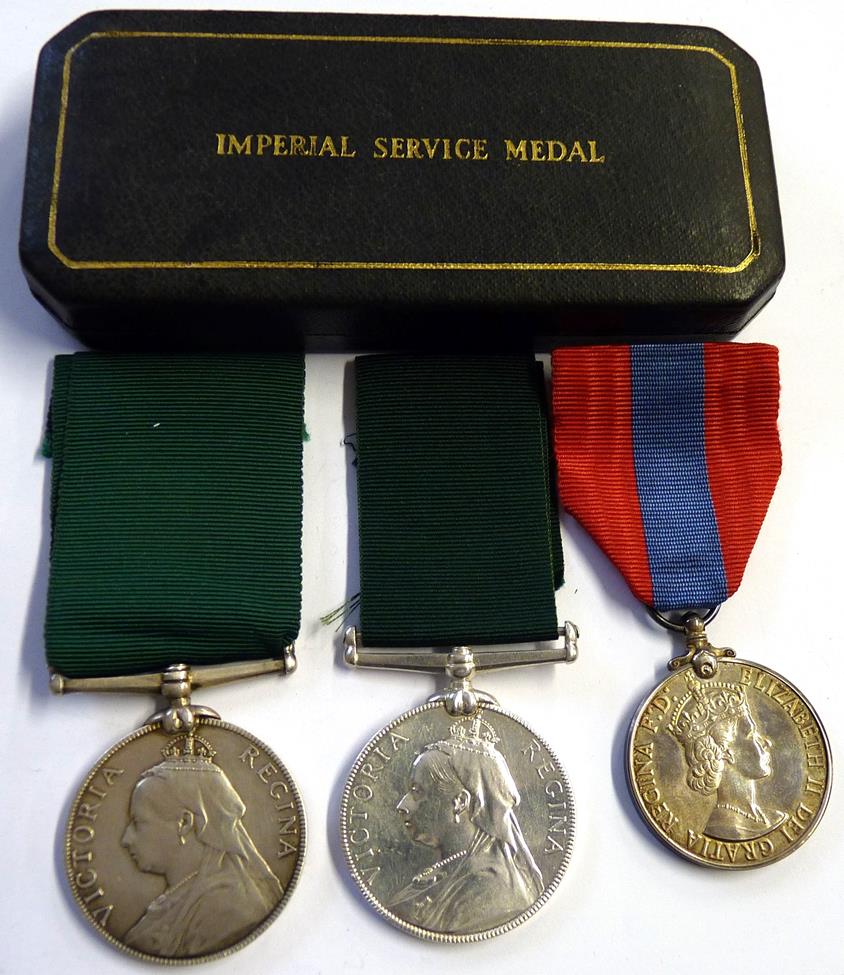 Lot 4 - Two Volunteer Long Service Medals, (Victoria Regina), un-named; an Imperial Service Medal,...