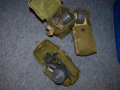 Lot 61 - Five Second World War Gas Masks, with two webbing cases; also, eight 1970's/80's gas masks and...