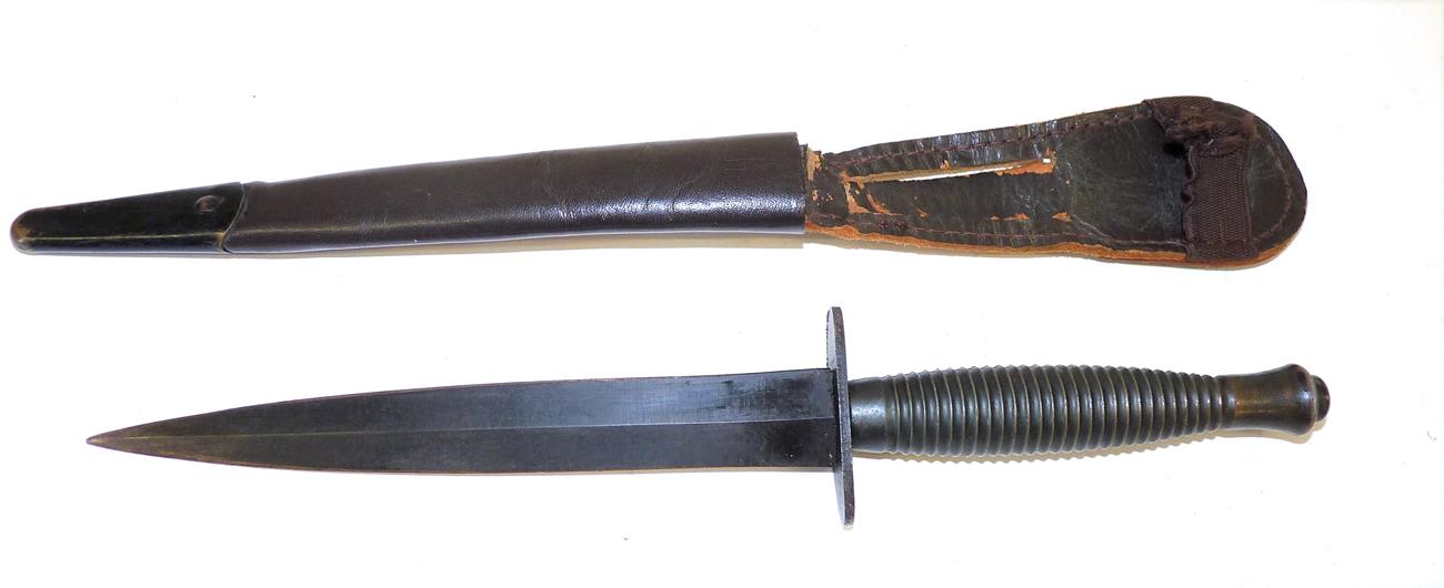 Lot 129 - A Third Pattern Commando Knife, with blackened machine forged steel blade, the crossguard...
