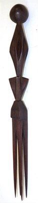Lot 132 - A Fijian Cannibal Fork, of dark reddish wood, with four long tangs, triangular block carved...