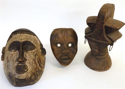 Lot 134 - An Igbo Mask, with cream pigment to the face below a domed head with dentil carved fringe,34cm;...