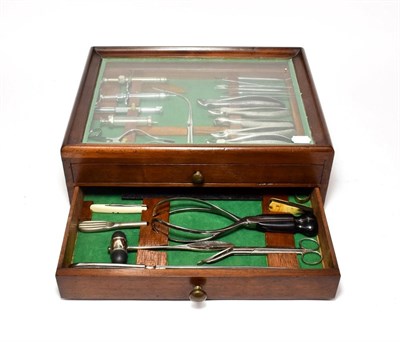 Lot 2114 - Surgical Instruments Set in two drawer mahogany cabinet with glazed top 17x13x6'', 43x33x15cm