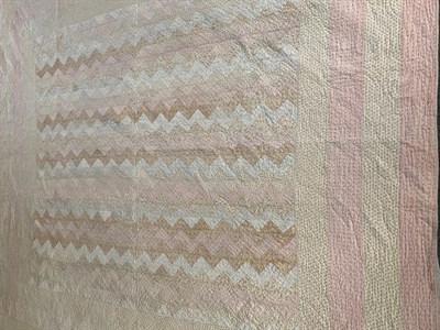Lot 2214 - Late 19th century pale pink and cream sprigged quilt; and another in blue stripes