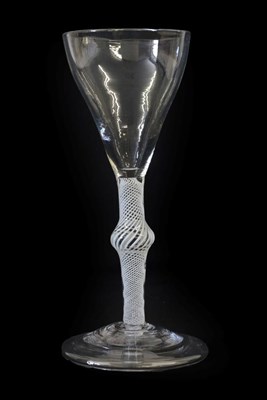Lot 13 - A Wine Glass, circa 1750, the tulip shaped bowl on an opaque twist stem with central knop and...
