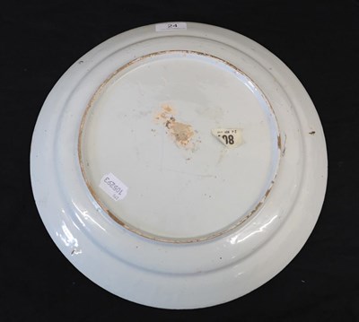 Lot 24 - An English Delft Plate, mid 18th century, painted in colours with a central flowerspray within...