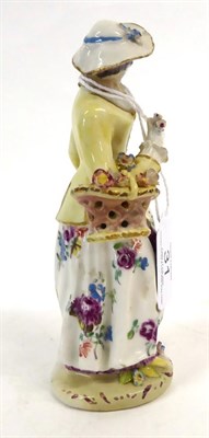 Lot 31 - A Bow Porcelain Figure of a Lady, circa 1760, standing wearing a yellow jacket and flowered...