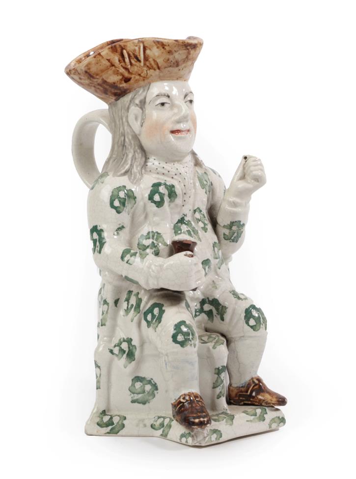 Lot 53 - A Staffordshire Pottery Squire Toby Jug, 19th century, the seated figure with brown hat and...