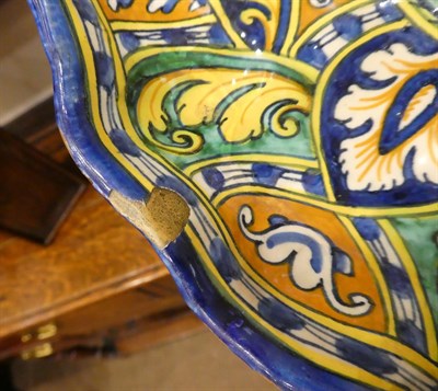 Lot 65 - A Faenza Maiolica Crespina, circa 1550, of lobed circular form, painted in colours with a recumbent