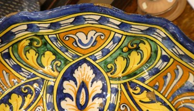 Lot 65 - A Faenza Maiolica Crespina, circa 1550, of lobed circular form, painted in colours with a recumbent