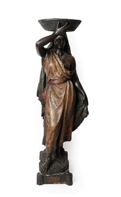 Lot 72 - A Goldscheider Painted Terracotta Figure of a Nubian Girl, circa 1900, standing wearing loose...