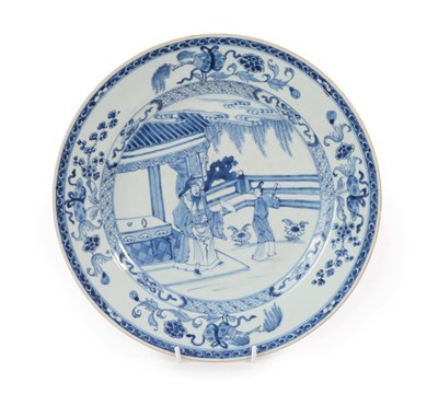 Lot 95 - A Chinese Porcelain Dish, Kangxi, painted in underglaze blue with figures in a fenced garden within