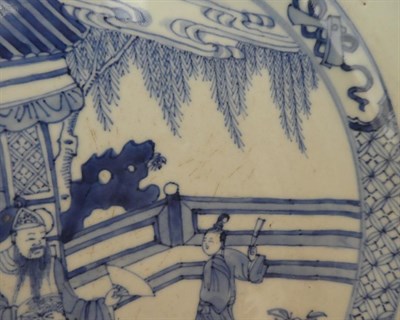 Lot 95 - A Chinese Porcelain Dish, Kangxi, painted in underglaze blue with figures in a fenced garden within
