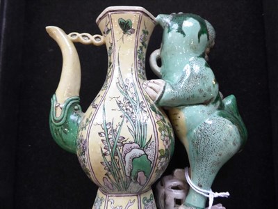 Lot 103 - A Pair of Chinese Bisque Ewers and A Cover, in Kangxi style, of baluster form with dog of fo...