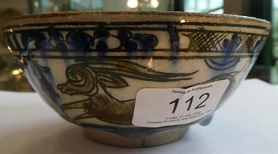 Lot 112 - A Persian Faience Bowl, possibly 16th century, painted in underglaze blue and brown with...