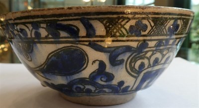 Lot 112 - A Persian Faience Bowl, possibly 16th century, painted in underglaze blue and brown with...
