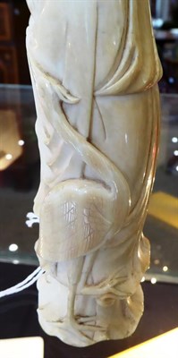 Lot 122 - A Chinese Ivory Figure of a Sage, 19th century, standing wearing flowing robes holding a ruyi...