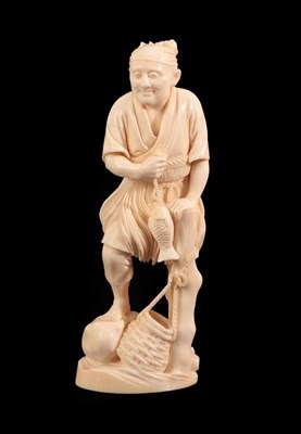 Lot 140 - A Japanese Ivory Okimono as a Fisherman, Meiji period, standing holding a fish on a line leaning on