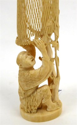 Lot 141 - A Japanese Ivory Okimono as a Fisherman, Meiji period, kneeling mending a net hung from a tall...