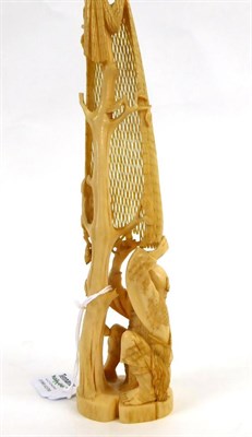 Lot 141 - A Japanese Ivory Okimono as a Fisherman, Meiji period, kneeling mending a net hung from a tall...