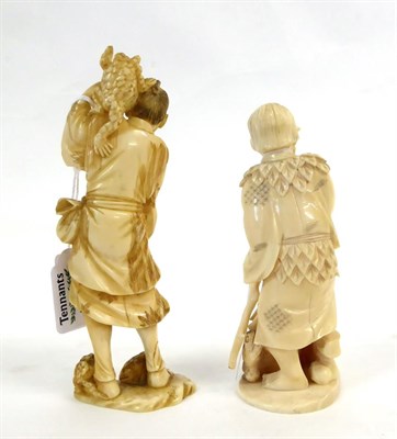 Lot 144 - A Japanese Ivory Okimono as a Woodsman, Meiji period, carrying a staff and two toads, a further...