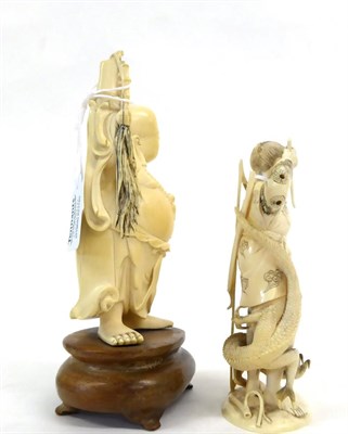 Lot 145 - A Japanese Ivory Okimono as a Samurai, Meiji period, standing holding a knife, a dragon at his...