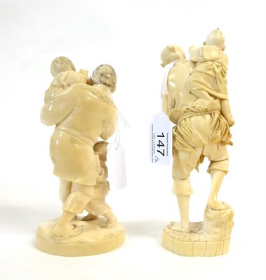 Lot 147 - A Japanese Ivory Okimono as a Father, Meiji period, holding a bird in one hand, a child in the...
