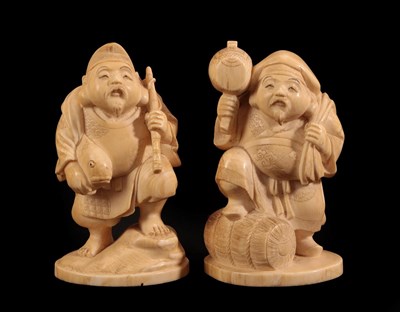 Lot 148 - A Japanese Ivory Okimono as Daikoku, Meiji period, standing holding a mallet and bag, one foot on a