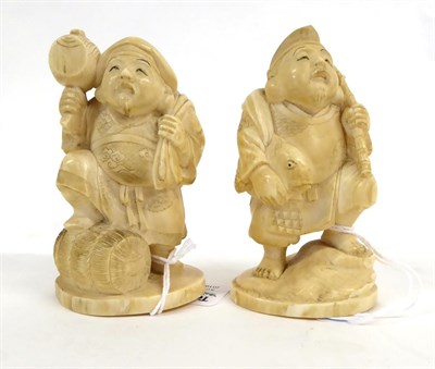 Lot 148 - A Japanese Ivory Okimono as Daikoku, Meiji period, standing holding a mallet and bag, one foot on a