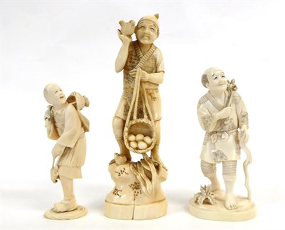Lot 151 - A Japanese Ivory Okimono as a Farmer, Meiji period, standing holding a bird and a basket of eggs, a