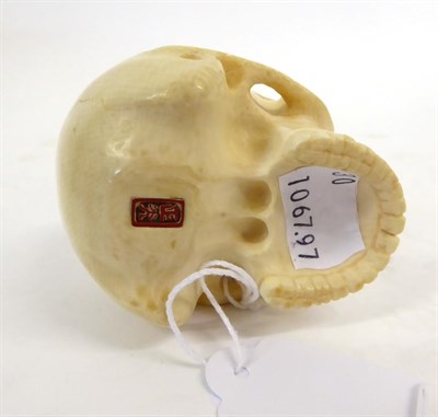 Lot 153 - A Japanese Ivory Okimono as a Skull, Meiji period, naturalistically carved, signed to red...