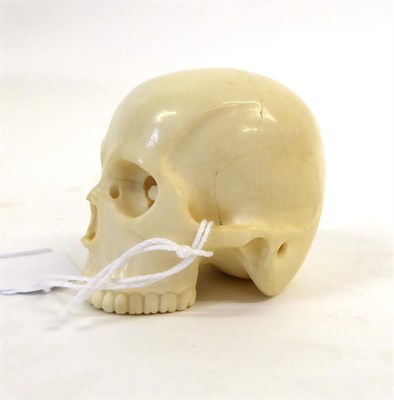 Lot 153 - A Japanese Ivory Okimono as a Skull, Meiji period, naturalistically carved, signed to red...