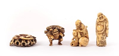 Lot 156 - A Japanese Ivory Netsuke, 19th century, as an Oni carrying a mask and a bag, signed, 3.5cm...