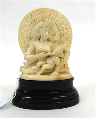 Lot 158 - An Indian Carved Ivory Group, late 19th/early 20th century, as a deity sitting before a halo...
